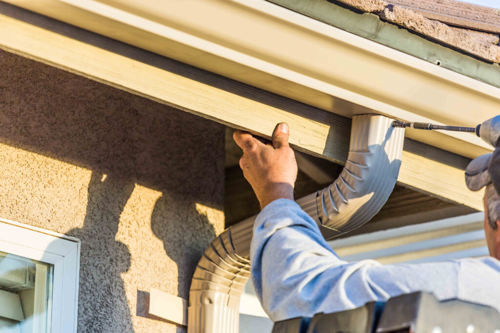 man installing a gutter