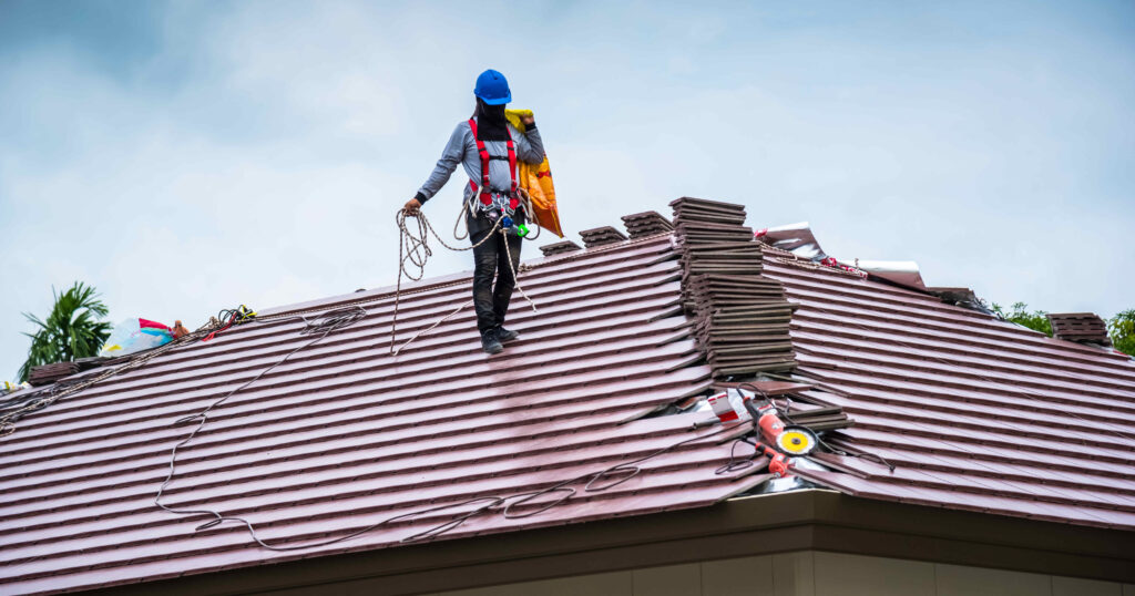 Roofer fixing a residential roof